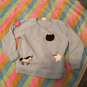 Baby blue sweatshirt with patches